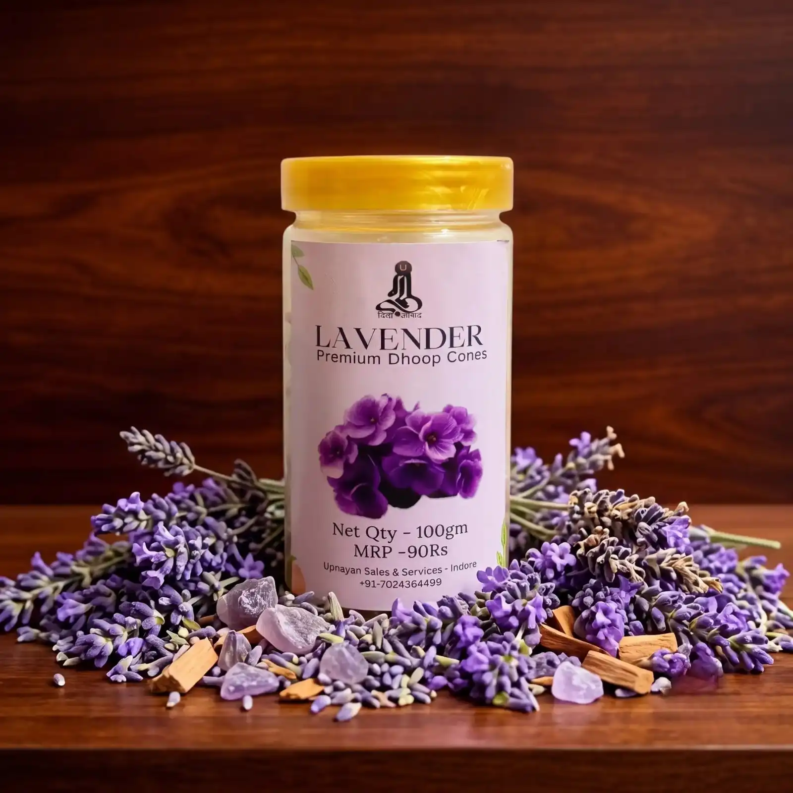 GURU Lavender Dhoop Cones jar resting on dark wood surrounded by purple lavender flowers
