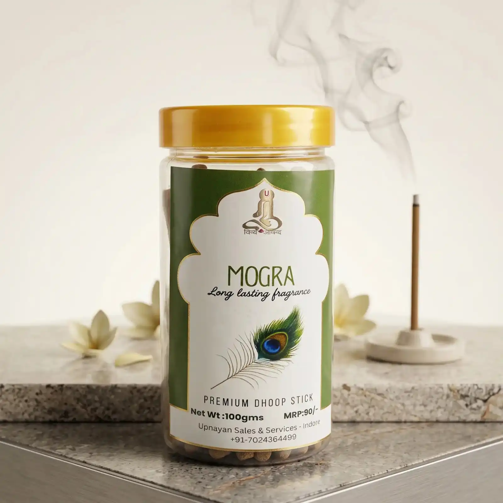 GURU Mogra Premium Dhoop Stick jar with peacock feather artwork on label and lit stick in background