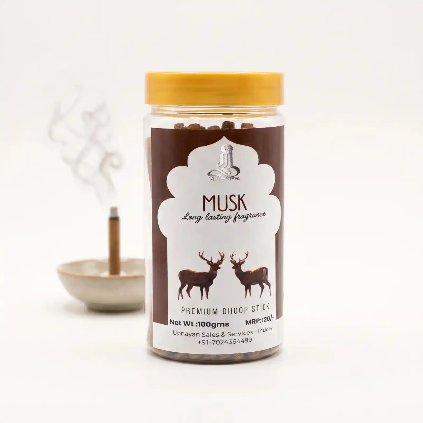 GURU Musk Premium Dhoop Stick jar with deer artwork label and burning dhoop stick in dish